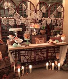 a table topped with lots of cakes and candles