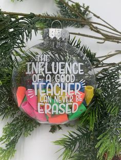 a glass ornament with writing on it