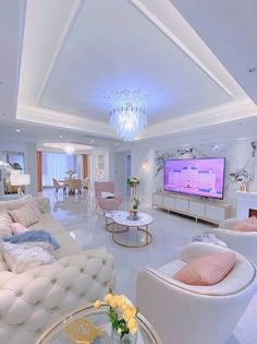 a living room filled with furniture and a flat screen tv mounted on the wall above a fireplace