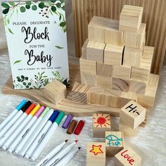 wooden blocks and crayons are sitting on the floor next to an adult coloring book