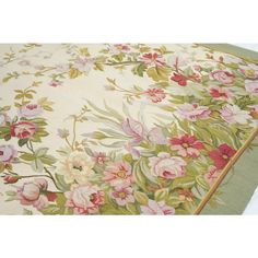 an area rug with flowers and leaves on it