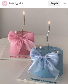 two cakes with bows and candles on top of each one, both decorated in blue and pink