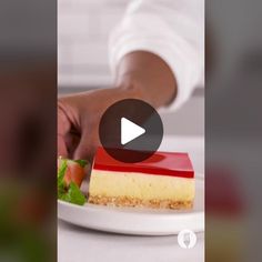 a person is placing a piece of cake on a plate with strawberries and carrots