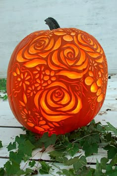 a carved pumpkin sitting on top of a wooden table