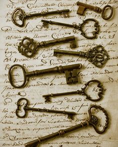 old keys are laying on top of an antique manuscript