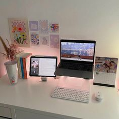 a laptop computer sitting on top of a white desk