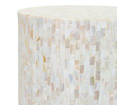 a white stool made out of mother of pearl tiles