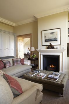 a living room filled with furniture and a fire place in the middle of a room