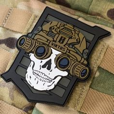 a patch with a skull and binoculars on it