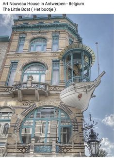 an old building with a boat on the front and side of it's windows