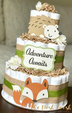 a three tiered cake decorated with woodland animals