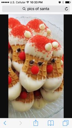 some christmas themed waffles are on a glass plate with white frosting and red sprinkles