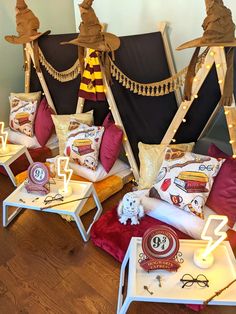 a room filled with lots of pillows covered in harry potters hats and scarves