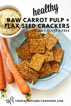 carrots and crackers on a plate with the text healthy raw carrot pulp + flax seed crackers vegan gluten free