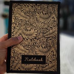 a hand holding up a notebook with the word tollbook on it's cover