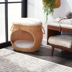 a wicker basket sitting on top of a wooden table next to a white rug