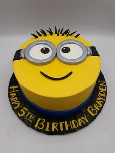 a birthday cake with a minion face on it