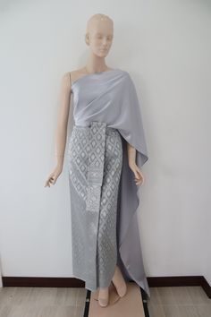 Silver-greenish gray  Thai/ Khmer outfit, "Chut thai" for women.  Occasions: Songkran festival, Loy krathong festival, bride made dress, Thai fair, Thai exibition, attended Thai wedding, temple ceremony, making merit etc. The set consists of 1.A wrap around skirt made from brocade faux silk fabric, the skirt can be adjust by hooks         Waist: 24-32 in. (61-81 cm)   Hips: 34-42 in. (86-107 cm)    Length: approx. 36.5 in. (92 cm) 2.Satin plain color Thai shawl/ sabai     Measurement: 18 in. x 118 in. (45 cm x 300 cm)  Care instructions:  Hand wash or machine wash on gentle cycle. Separately for excessive dye. Hang to dry under shade for extra care of its color.  Note:  -Due to the difference between different monitor, the picture will not reflect the actual color of the item. We guarantee Khmer Party Dress, Khmer Outfit, Adjustable Skirt, Loy Krathong, Khmer Dress, Songkran Festival, Festival Bride, Thai Wedding, Sarong Skirt