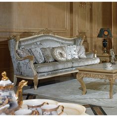 an ornately decorated living room with gold accents