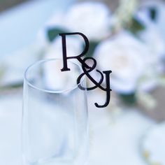 a close up of a wine glass with the letter p and j on it