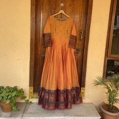 Traditional Anarkali suit usa / narayanpet dress / pure cotton kanchi handloom dress with big traditional border  /Handloom dresses / voggish / yellow  anarkali dress / cotton dress          Looking for a perfect indian dress/anarkali/suit sets that are trendy, unique and easy to carry !! yess, You are at the right place. we carry such versatile pieces of anarkalis and suit sets, kurtas that really let you stand out in any occassion !!      featuring this beautiful pure handloom kanchi cotton dress in dual tone orange color with traditional contrast borders with hand embroidery on the neck as shown !! A very classy, beautiful , traditional yet modern  , perfect and super comfy for any occasion !! Ready to ship , Can be customized in colors and patterns !! Pair it up with antique necklace/ Orange Contrast Colors Suit, Festive Cotton Maxi Dress, Long Sleeve Chanderi Churidar With Block Print, Long Sleeve Chanderi Anarkali Set With Block Print, Chanderi Long Sleeve Anarkali Set With Block Print, Designer Wear Long Sleeve Block Print Anarkali Set, Traditional Cotton Maxi Dress For Eid, Traditional Floor-length Cotton Salwar Kameez, Transitional Cotton Anarkali Set With Long Sleeves