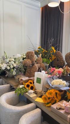 a table with sunflowers and other flowers on it