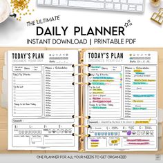 the ultimate daily planner printable with gold glitters and an open notebook on top