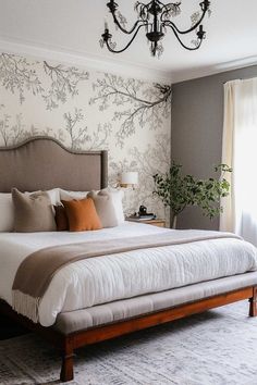 a bedroom with a large bed and a chandelier hanging from the ceiling above it