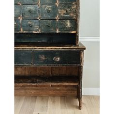 an old wooden dresser sitting on top of a hard wood floor