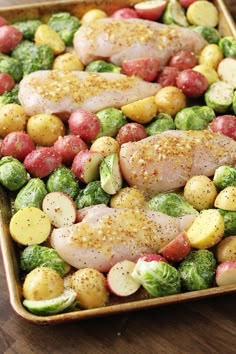 a casserole dish with chicken, potatoes and broccoli