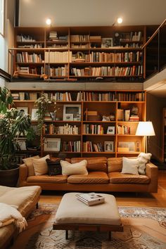 a living room filled with lots of furniture and bookshelves full of bookcases