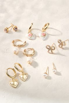 This versatile set includes six pairs of gold earrings, featuring a variety of styles from hoops to studs. Each piece is adorned with a delicate pendant, pearl, or jewel, offering endless possibilities for your accessorizing needs. Altard State Jewelry, Earring Pack, Inexpensive Jewelry, Delicate Pendant, Stud Set, Accessories Jewelry Earrings, Altar'd State, Dainty Earrings, Jewelry Inspo