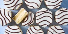 several pieces of cake with white frosting and chocolate drizzled on top