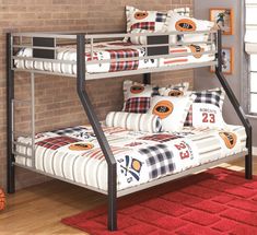 a bunk bed in a room with brick walls and hardwood floors, along with a red rug on the floor