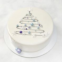 a white cake with a decorated christmas tree on it