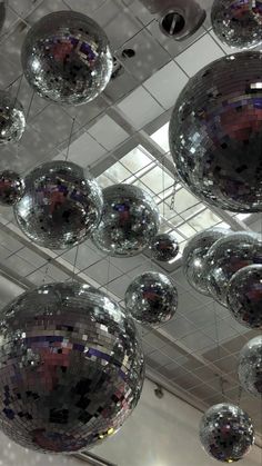 many shiny disco balls hanging from the ceiling