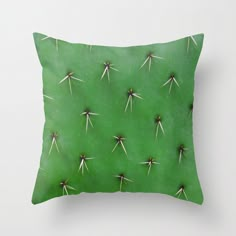 a green cactus with small white spikes on it's back throw pillow by artist and photographer