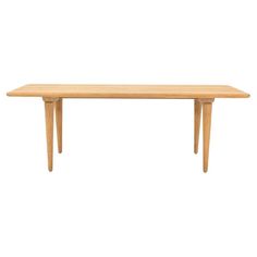 a wooden table with two legs and a long, narrow top on an isolated white background