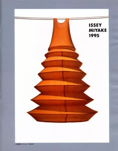 an image of a wooden christmas tree hanging from a line with the words issey nyake