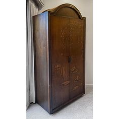 an old fashioned wooden cabinet sitting on the floor