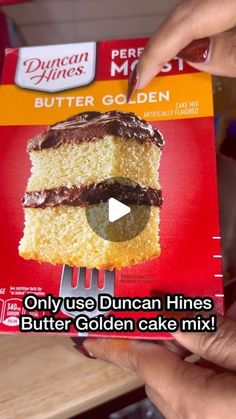 someone is holding up a box of cake mix that has been made into a piece of cake