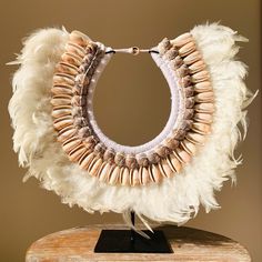 This magnificent Matahari necklace in feathers and shells can be placed on its base or hung on the wall. Its ethnic look will give style to your interior. The products we select are handmade by Balinese artists. Due to its handcraft production, each object has its singularity. Origin : Bali Materials : shells, feathers, cotton ropes Dimensions : length 43 cm, height without base 35 cm, with base 38 cm To know more about Ethny, don't hesitate to visit our website and to follow us on Instagram: ww Ethnic Looks, Balinese, Cotton Rope, Switzerland, Necklace Etsy, Bali, Decorative Items, Shells