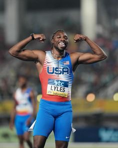 a man with his hands on his head in the middle of a race, celebrating