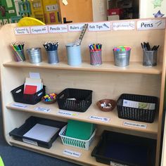 the shelves are filled with pens, pencils, and other office supplies in bins