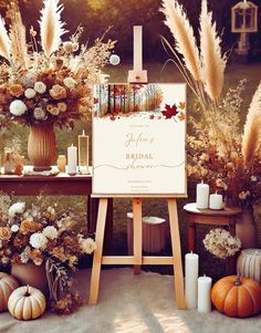 an easel with flowers and candles on it in front of a sign that says autumn bridal