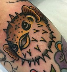 a close up of a person's arm with a tattoo on it and an animal