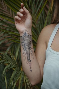 an elephant tattoo on the arm of a woman's left arm and right arm