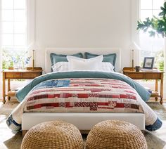 a bedroom with a bed, two stools and a plant on the side wall