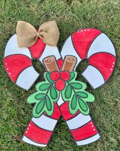 a christmas decoration on the grass with a bow