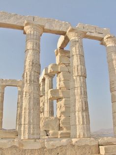 the ruins of an ancient city are shown against a blue sky